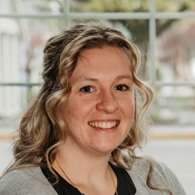 Close-up portrait of an individual with wavy, light-colored hair