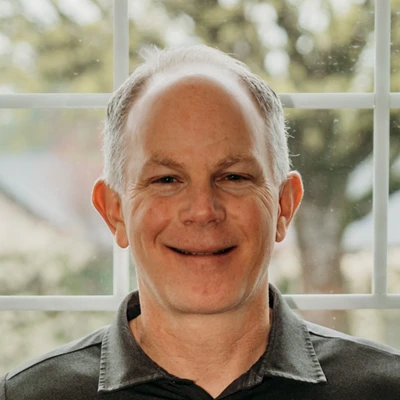 Close-up portrait of an individual smiling indoors